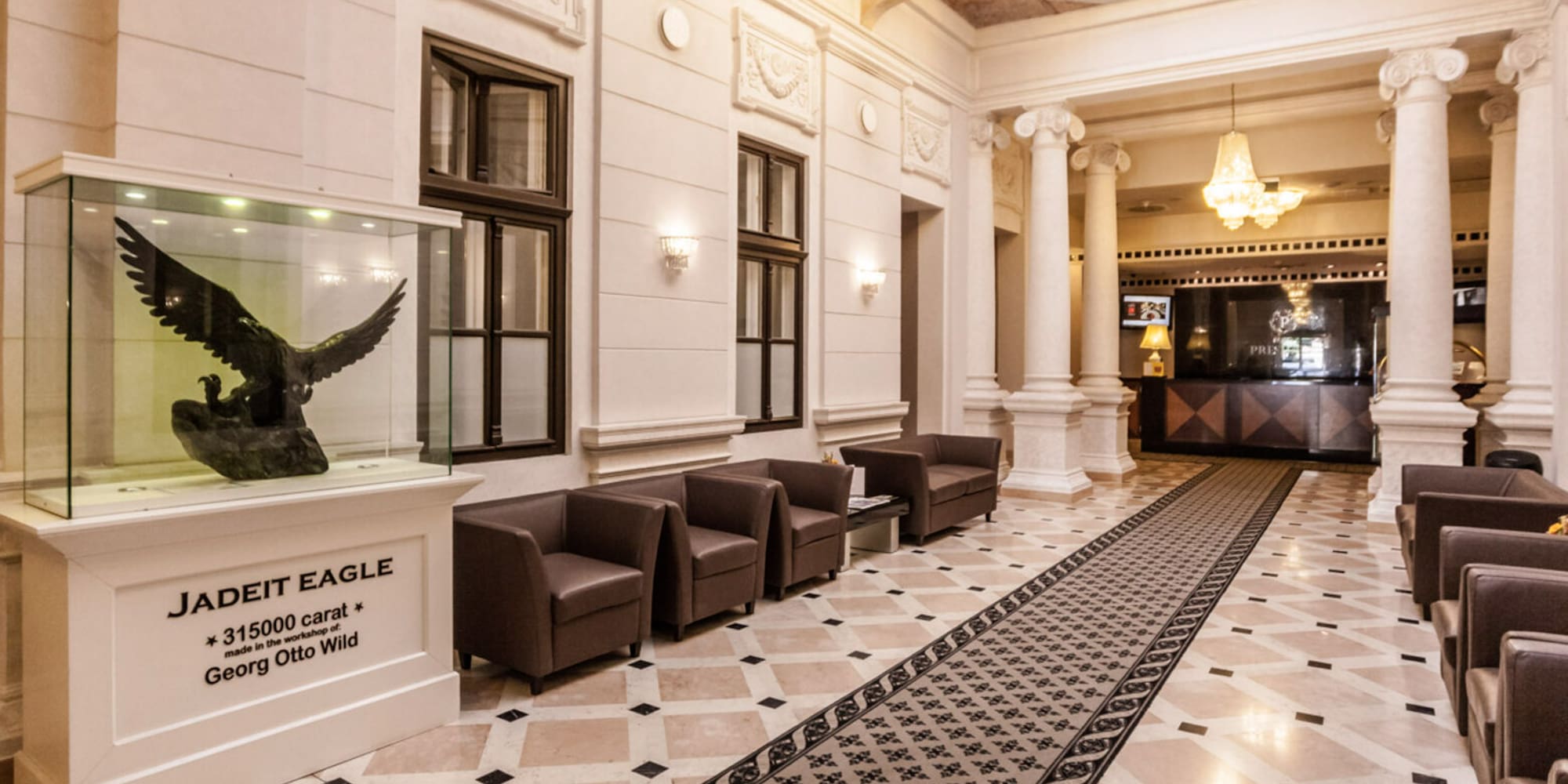 a lobby with a large glass case and a statue of an eagle