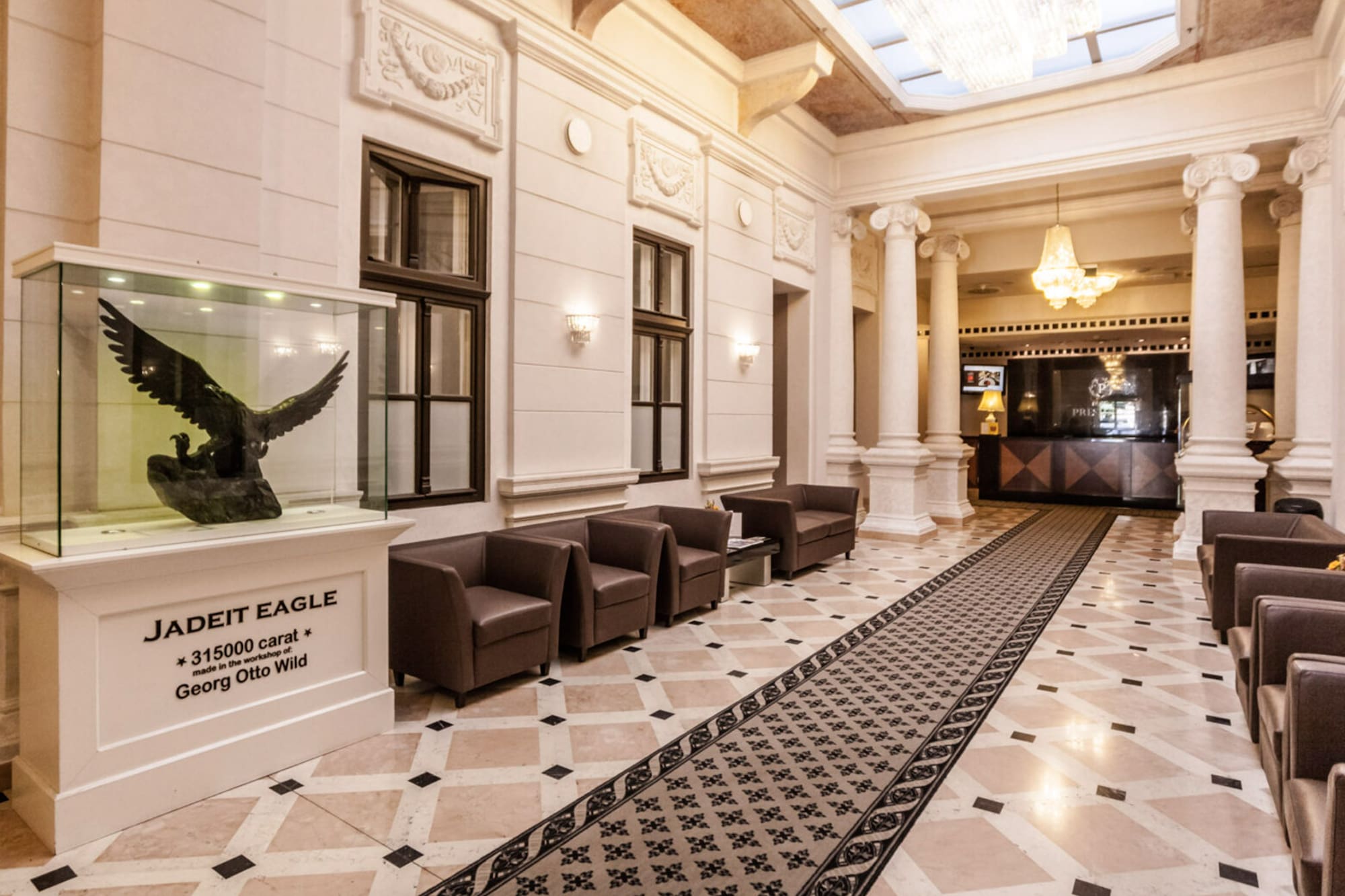 Elegant hotel lobby featuring Georg Otto Wild jadeite eagle sculpture and seating.