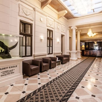 a lobby with a large glass case and a statue of an eagle