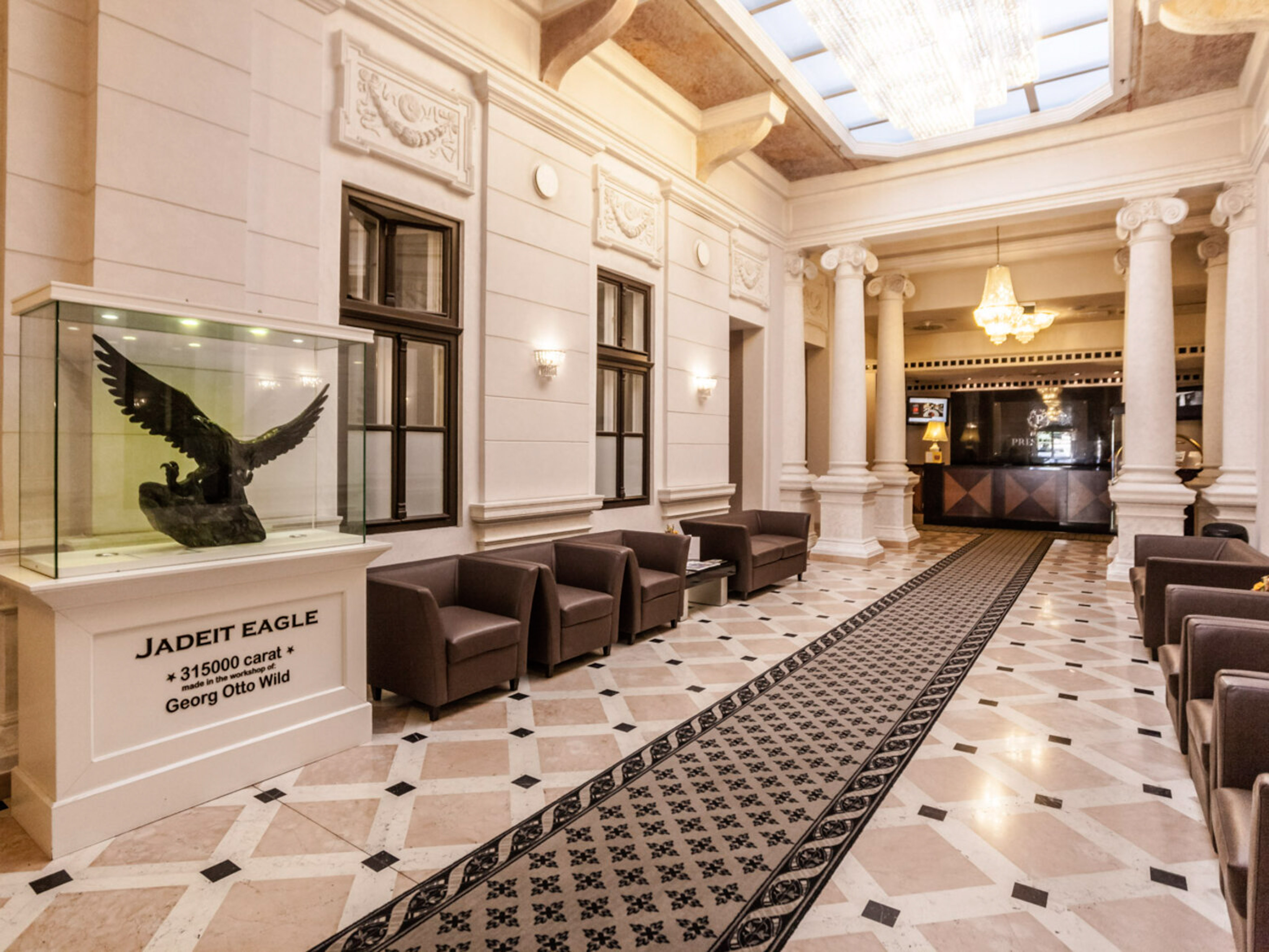 a lobby with a large glass case and a statue of an eagle