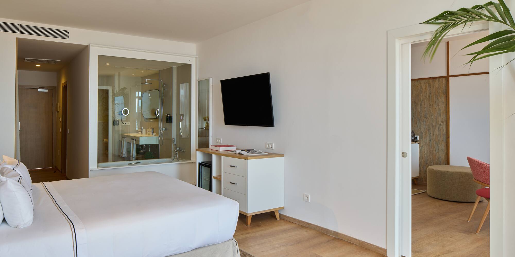 a bedroom with a tv and a wood floor