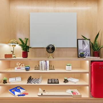 a shelf with books and a red refrigerator