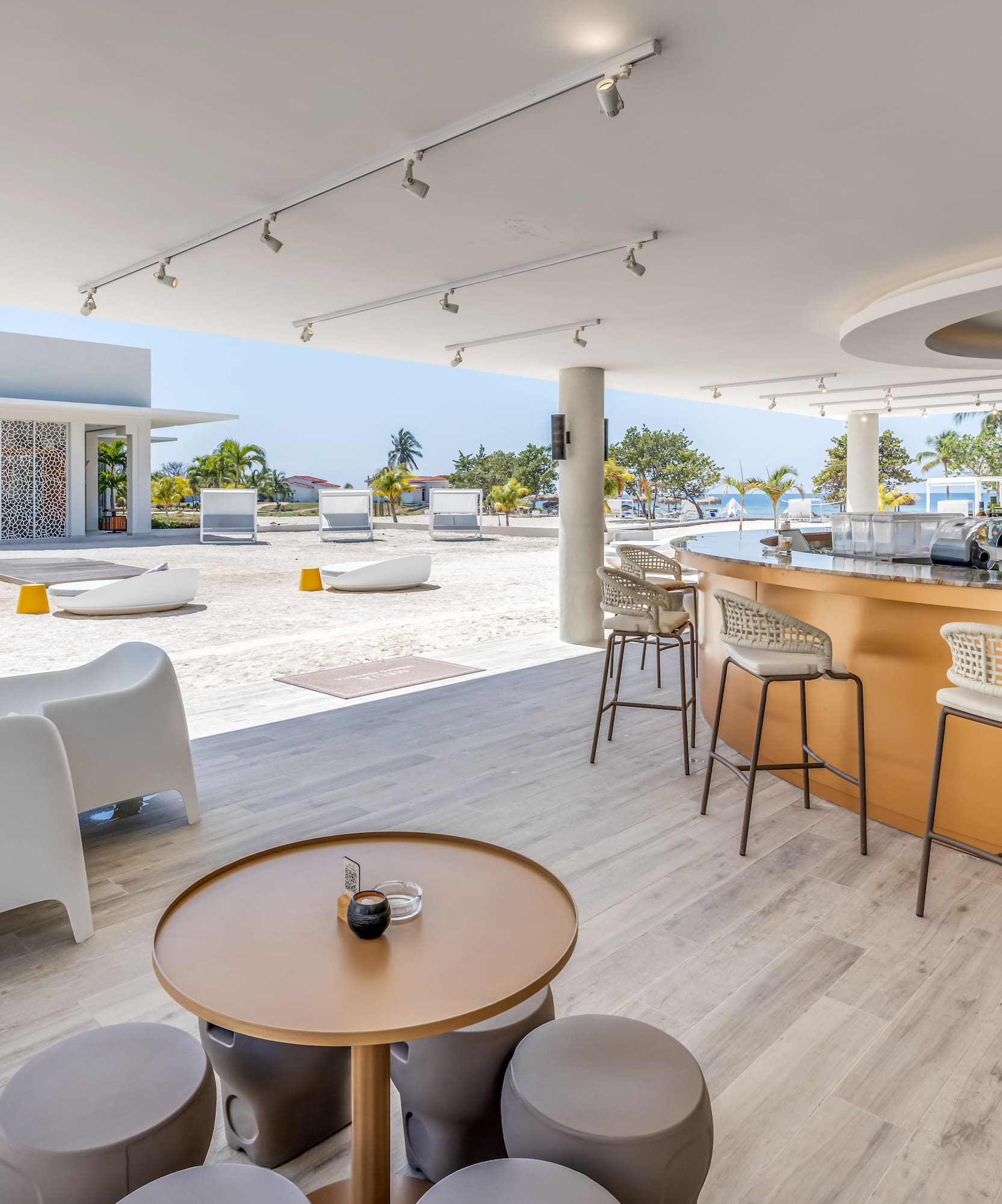 a bar with a table and chairs on a beach