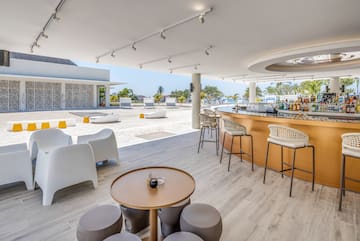 a bar with a table and chairs on a beach