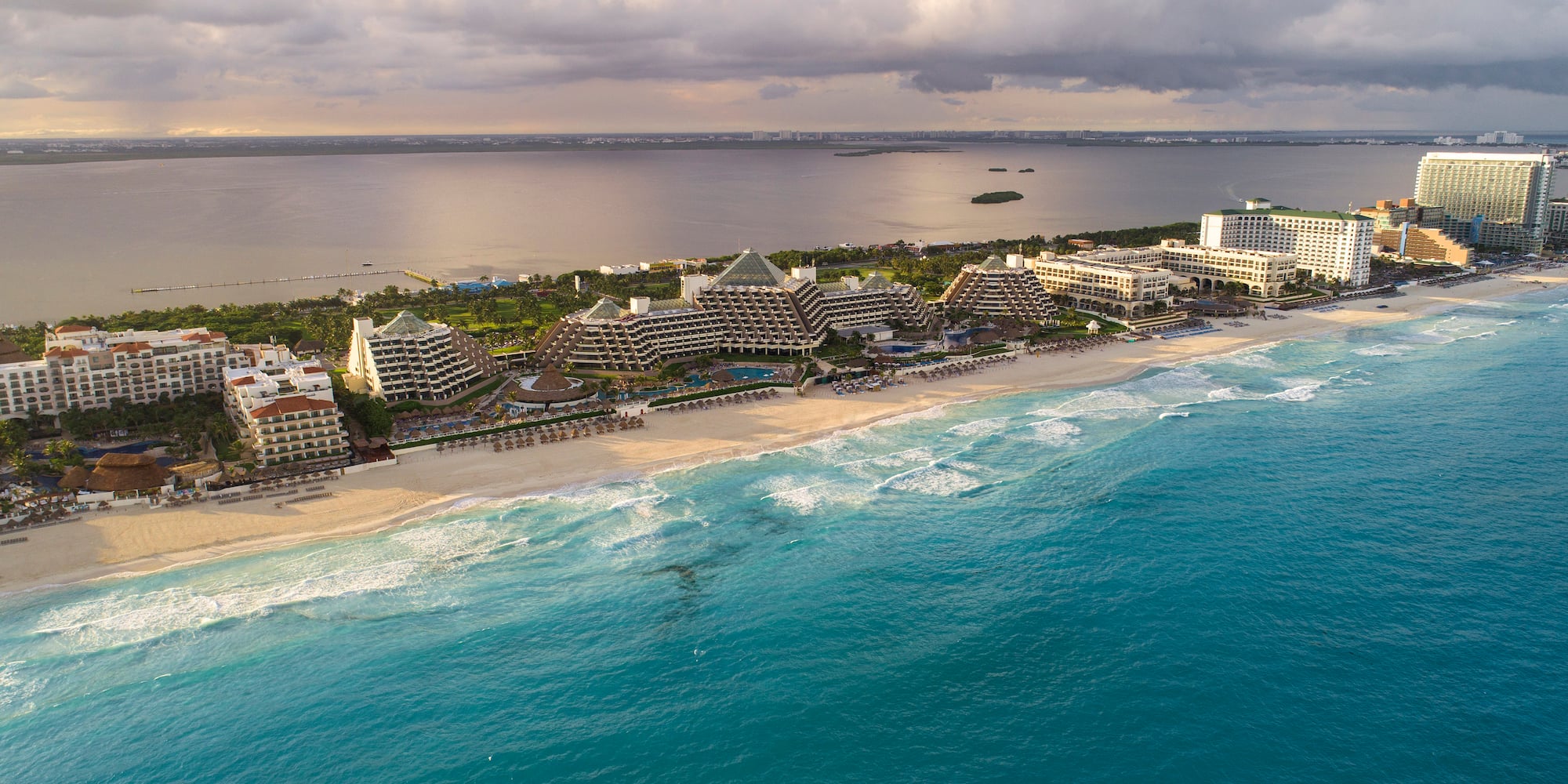 a beach with buildings and a body of water