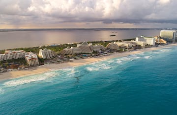 a beach with buildings and a body of water