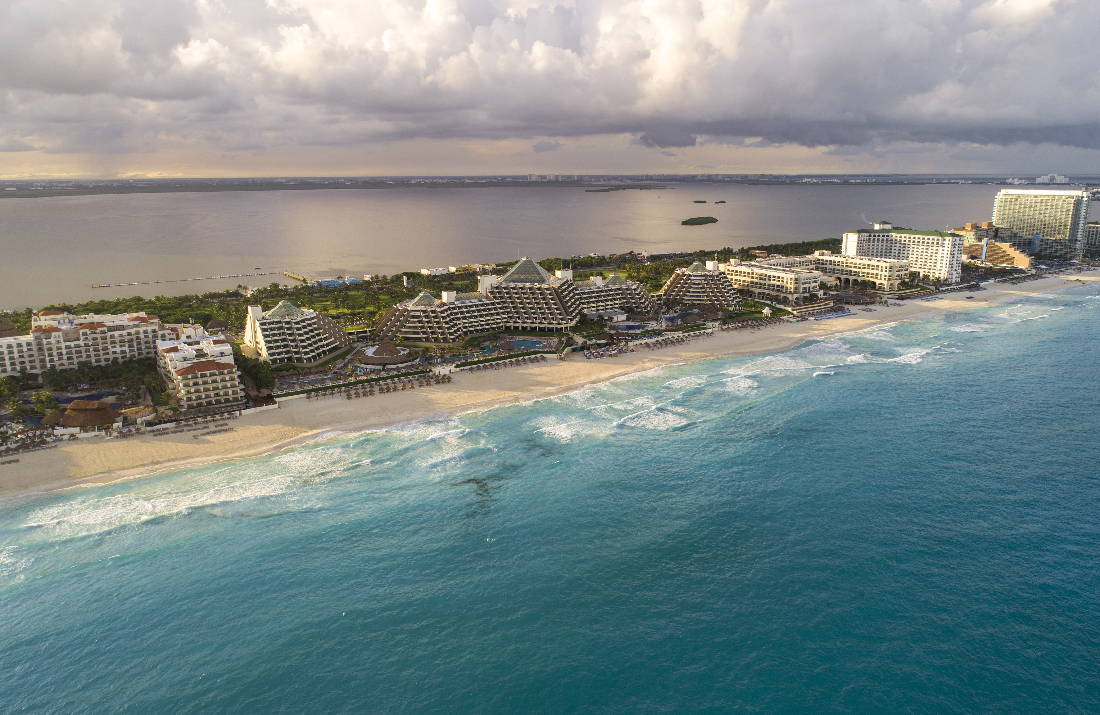 a beach with buildings and a body of water