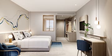 a bedroom with a bed and a tv