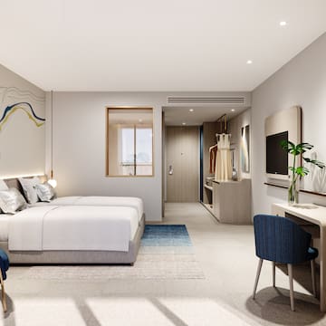 a bedroom with a bed and a tv