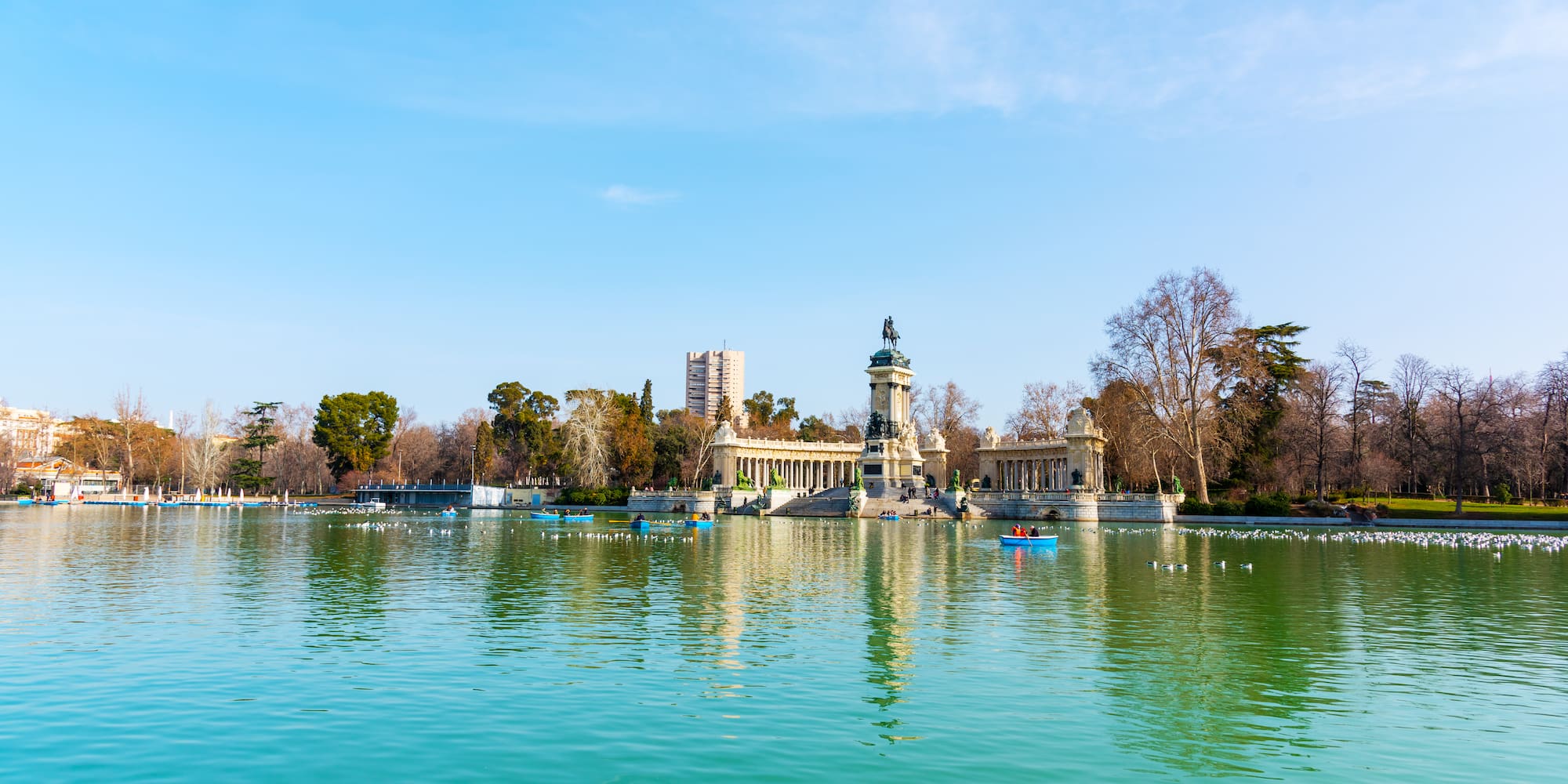 a body of water featuring a structure and several boats
