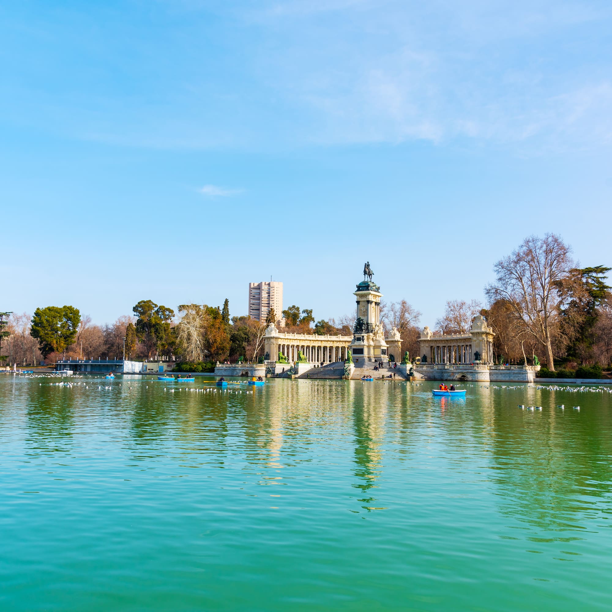 A body of water surrounded by a building and boats.