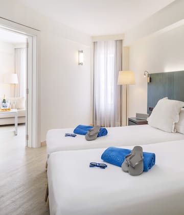 a room with two beds and a pair of sandals on it