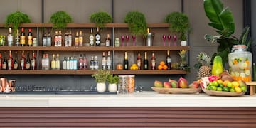 a bar with shelves of liquor and fruit