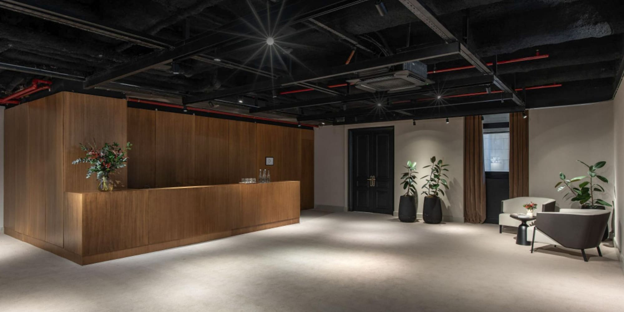 a room with a reception desk and plants