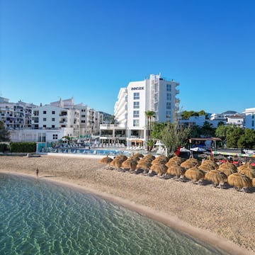 a beach with umbrellas and water