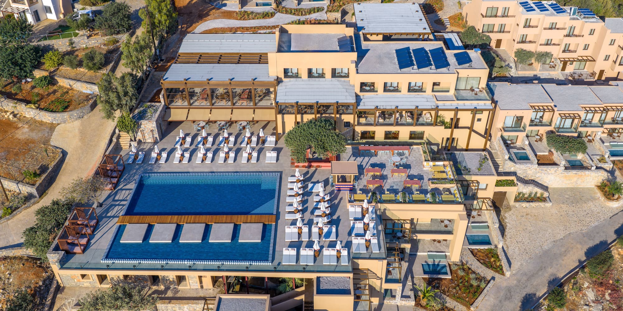 a building with a pool and chairs