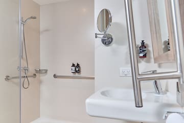a bathroom with a shower and a mirror