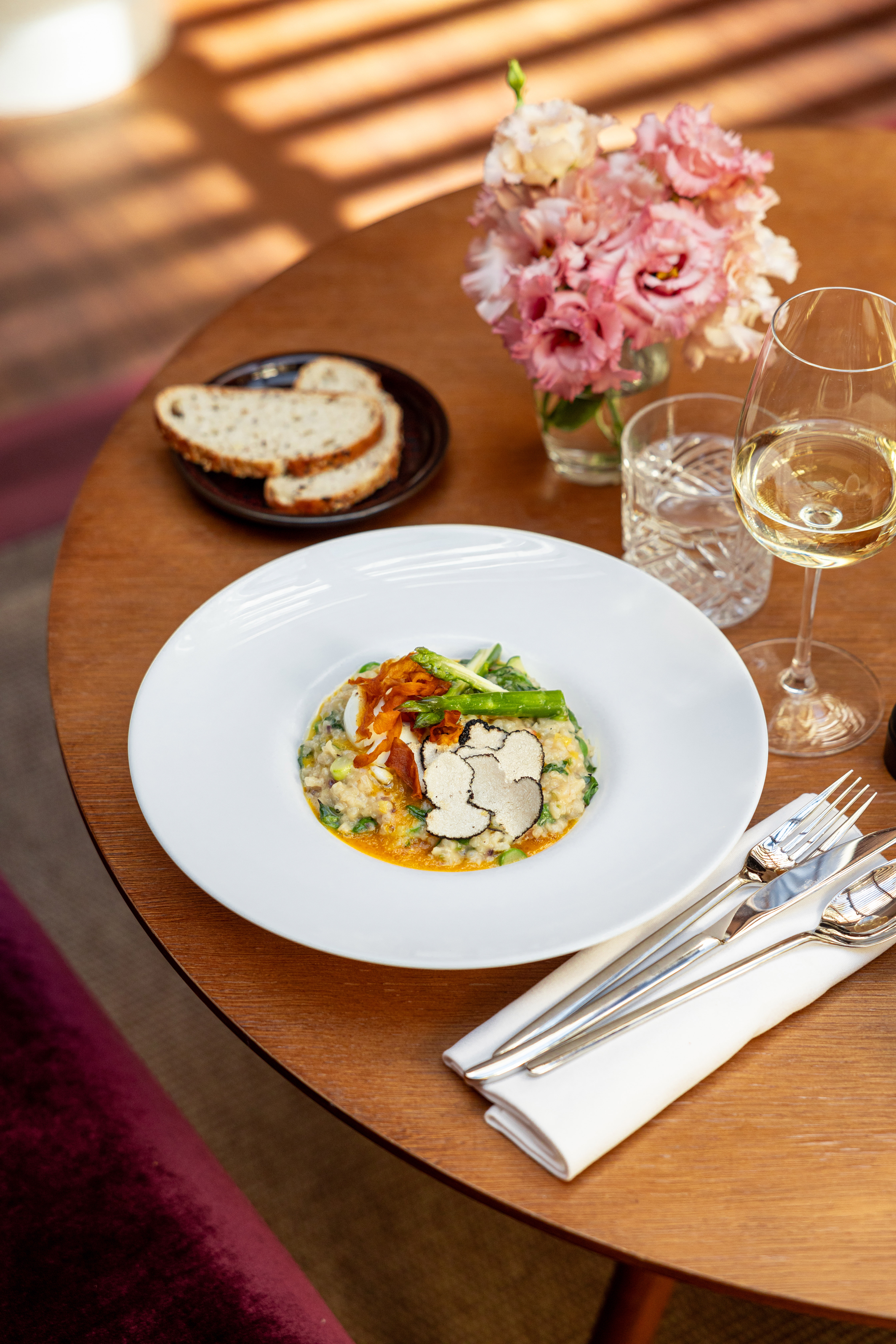 White truffle risotto with asparagus, poached egg, and white wine.