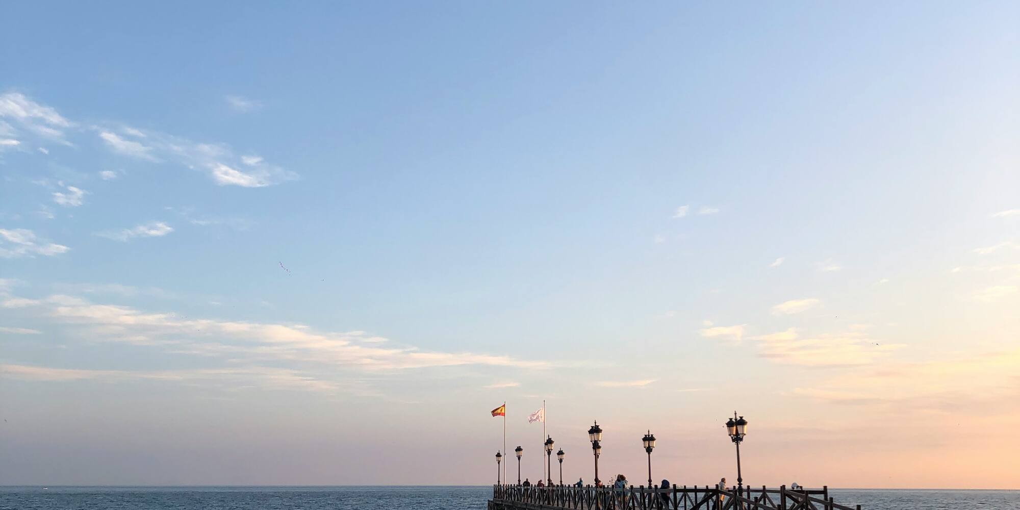 a pier with people walking on it