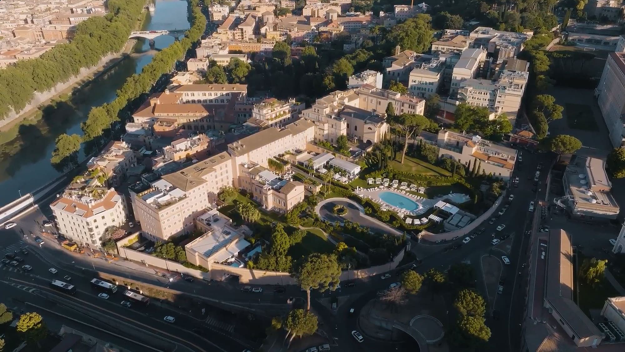 a large building with a pool and trees