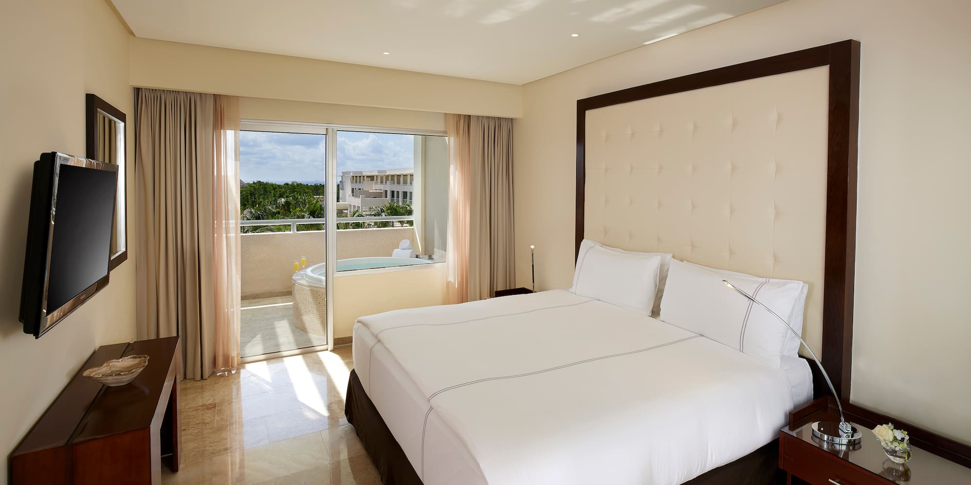 a bed in a room with a glass door