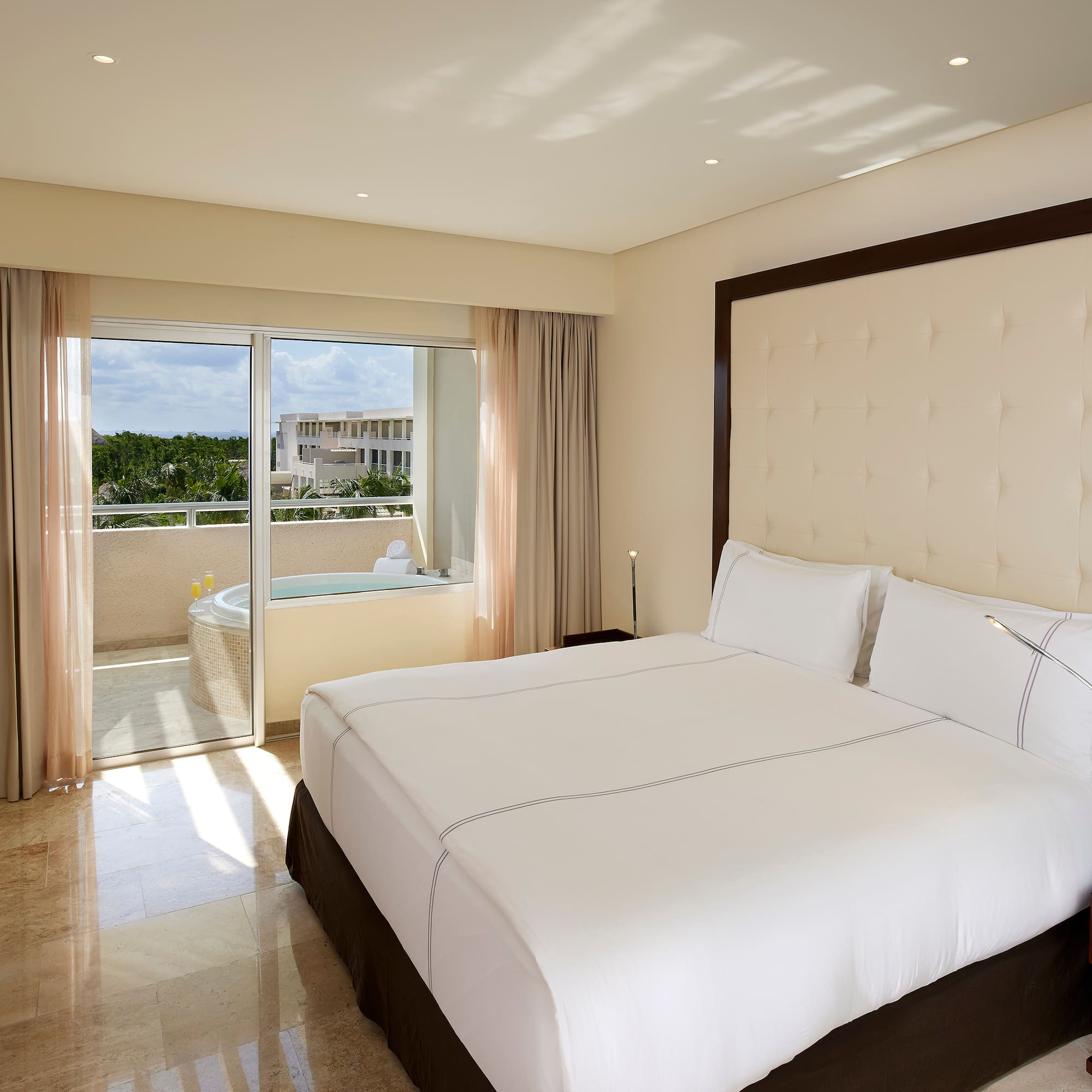 a bed in a room with a glass door