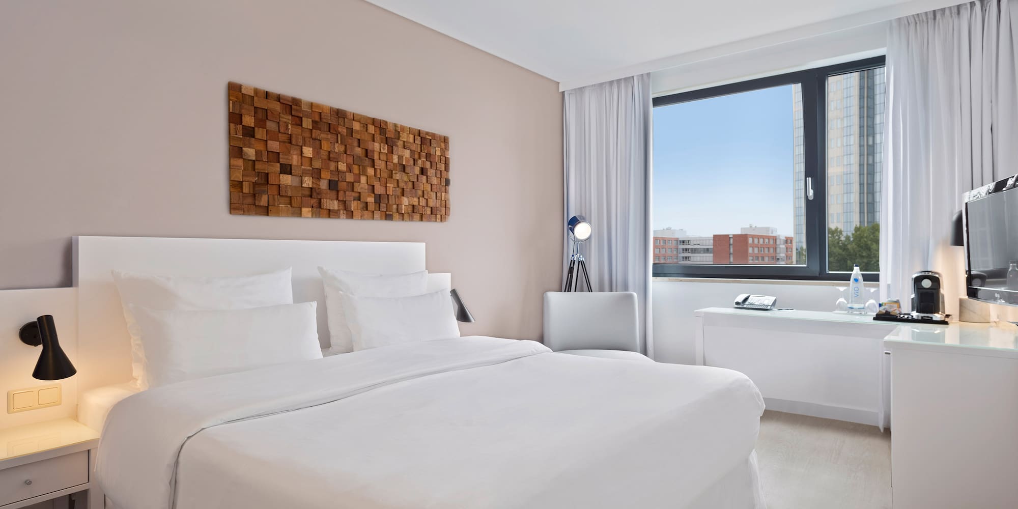 a bedroom with a large window and a bed