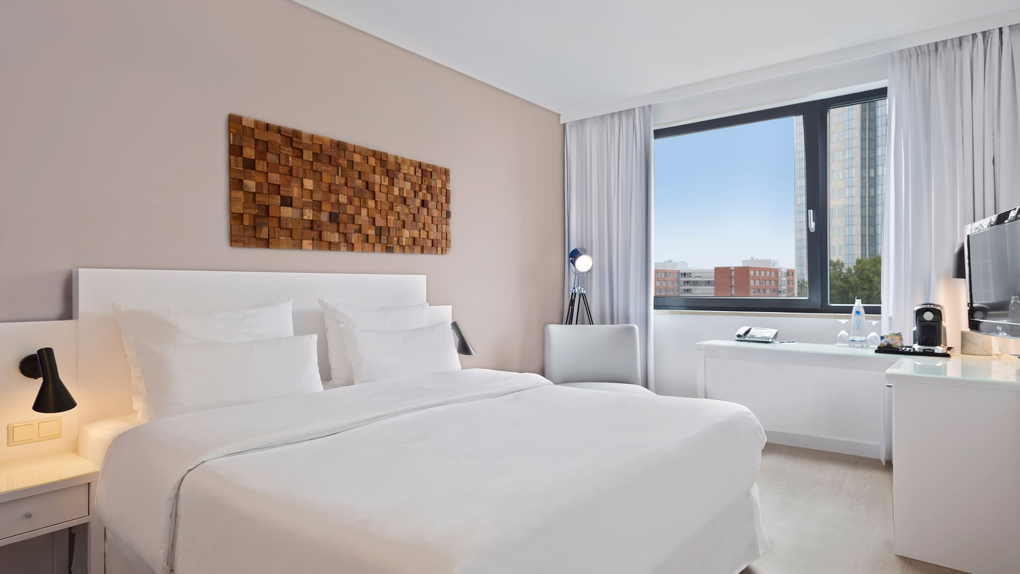 a bedroom with a large window and a bed