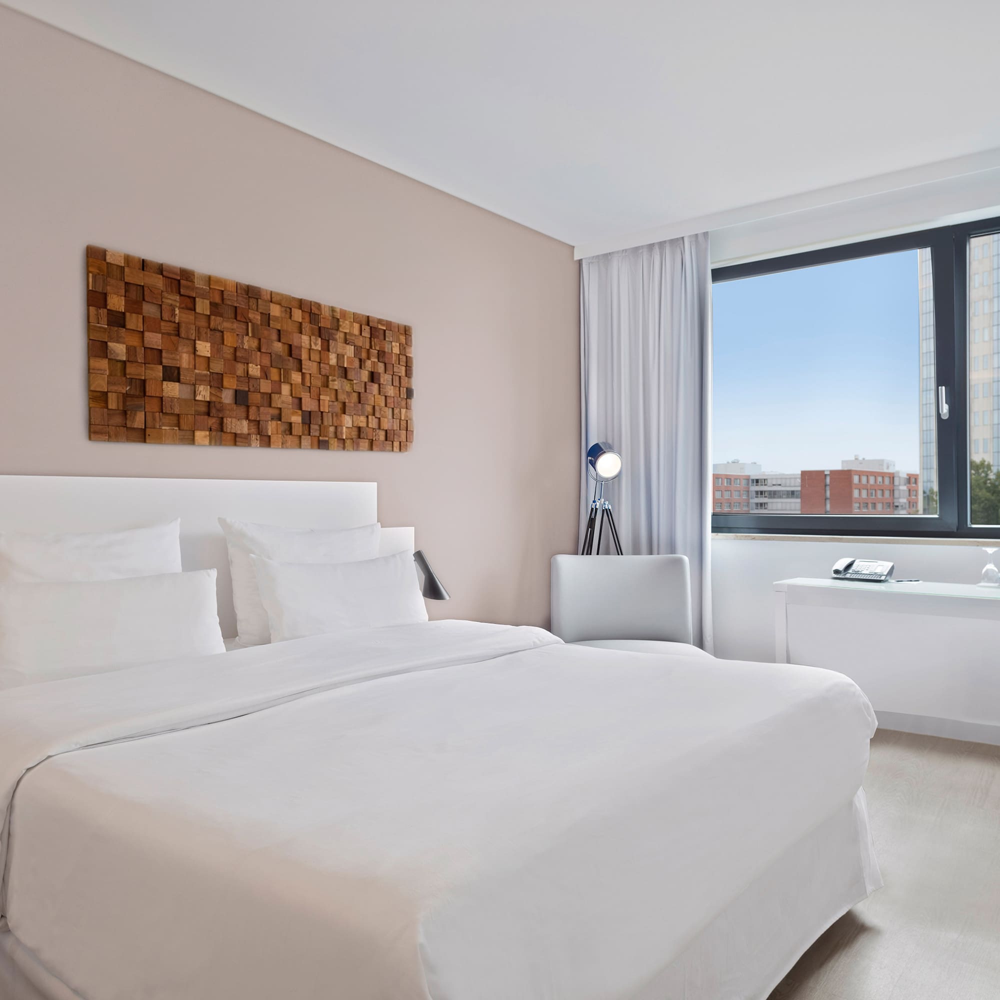 a bedroom with a large window and a bed