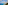 Panoramic turquoise beach, resort hotel, and coastal town under blue sky.