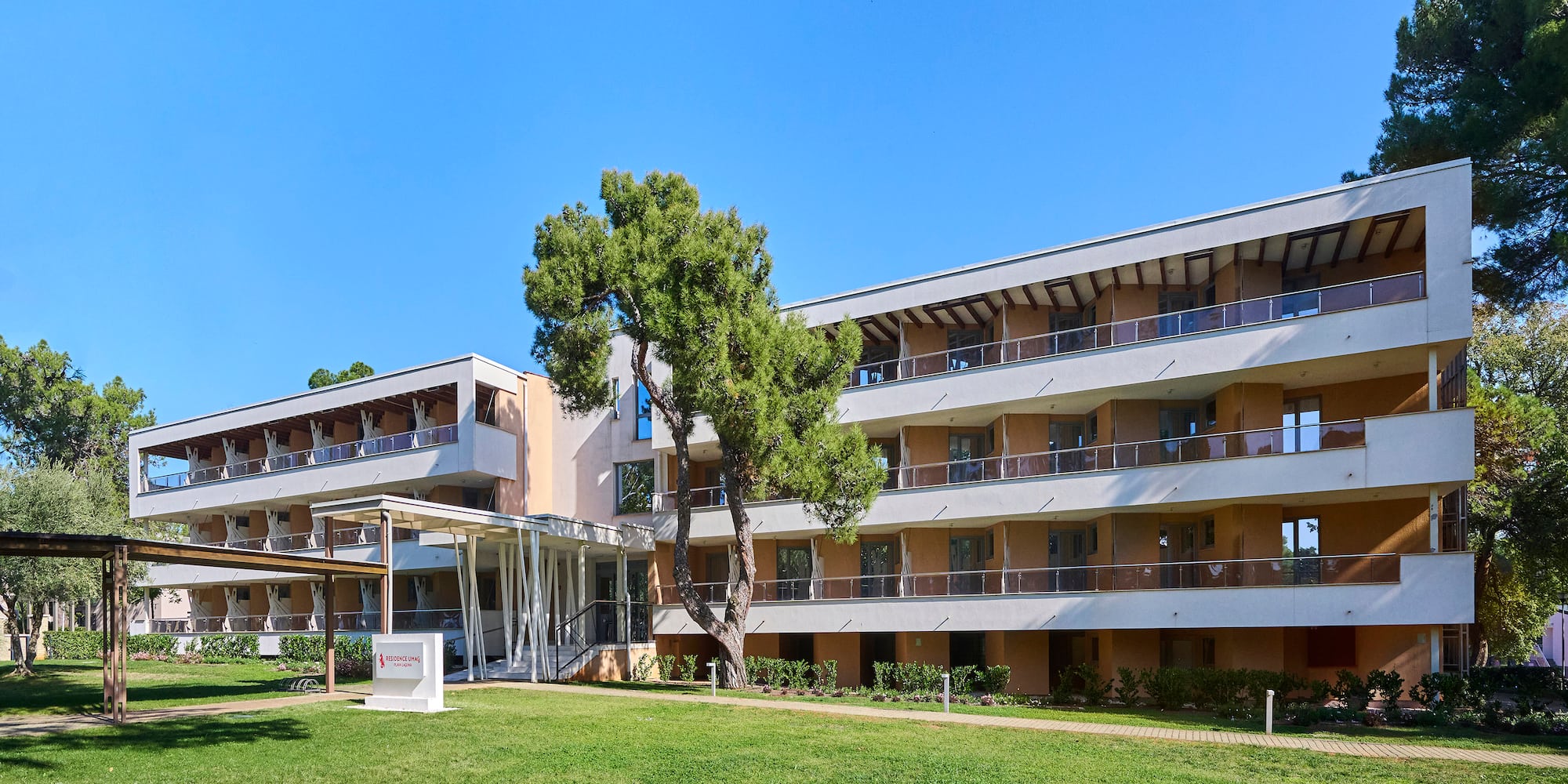 a building with a lawn and a tree