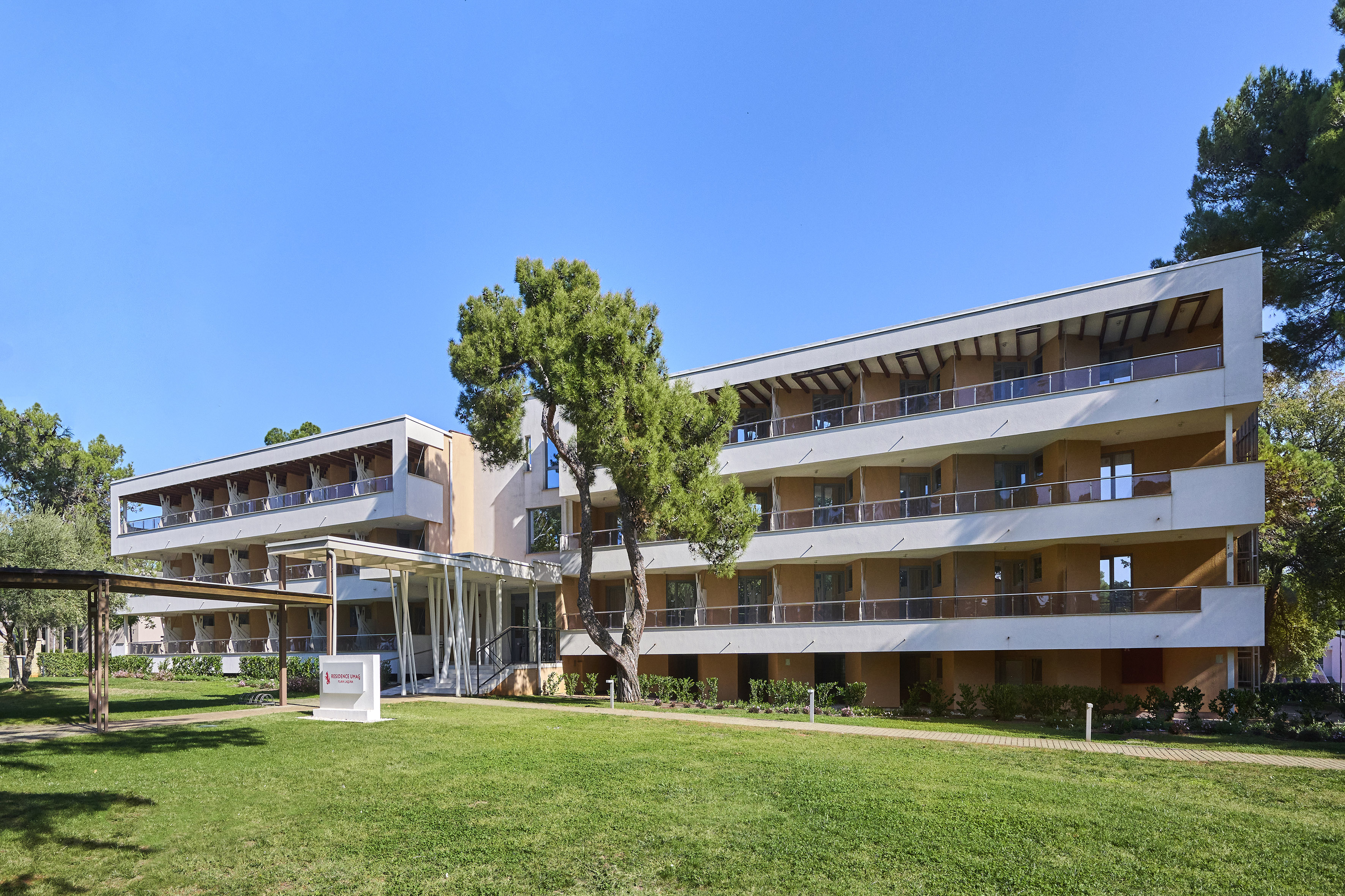 a building with a lawn and a tree
