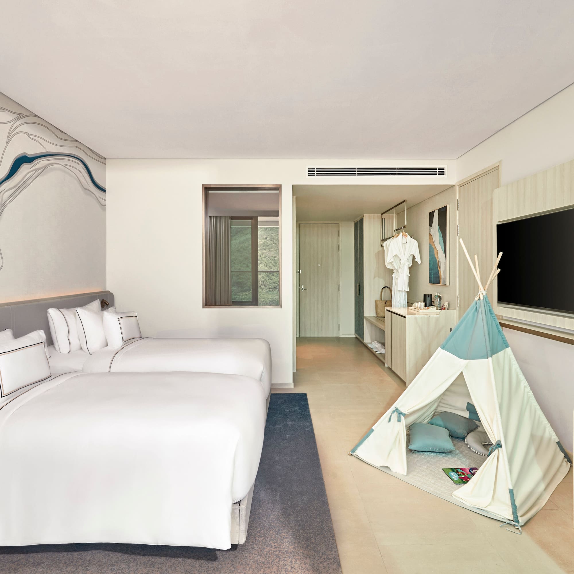 Modern hotel room with two beds, unique wavy wall art, and a children's teepee.