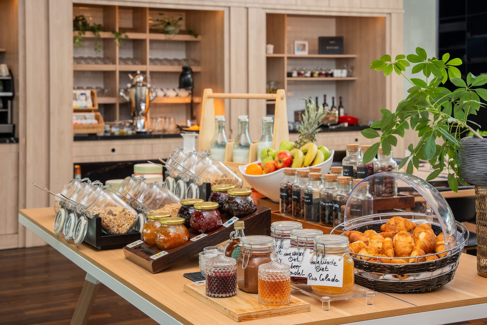 Continental breakfast buffet with fresh fruit, granola, croissants, and jams.