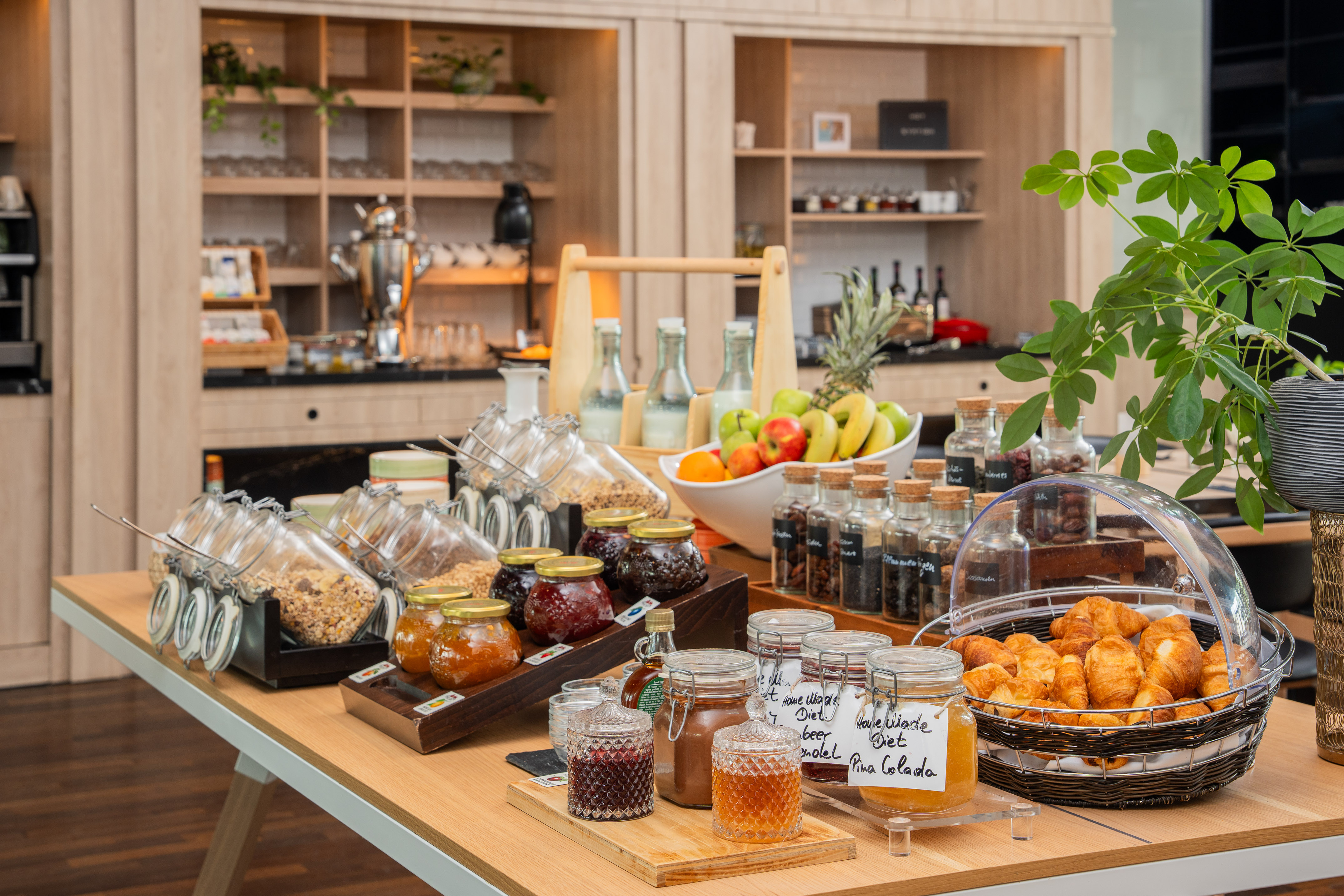 Continental breakfast buffet with fresh fruit, granola, croissants, and jams.
