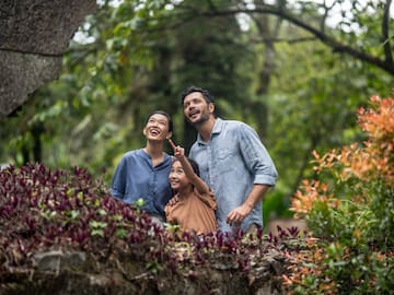 a group of people standing in a garden