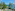 a beach with chairs and umbrellas and trees