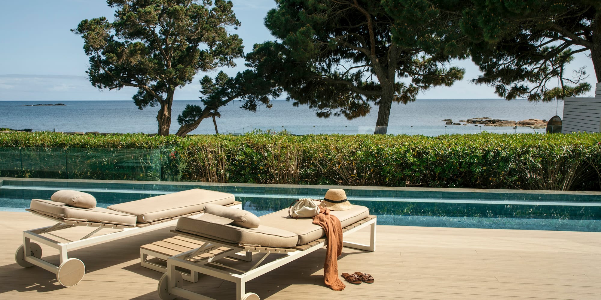 a pool with lounge chairs and a hat on it