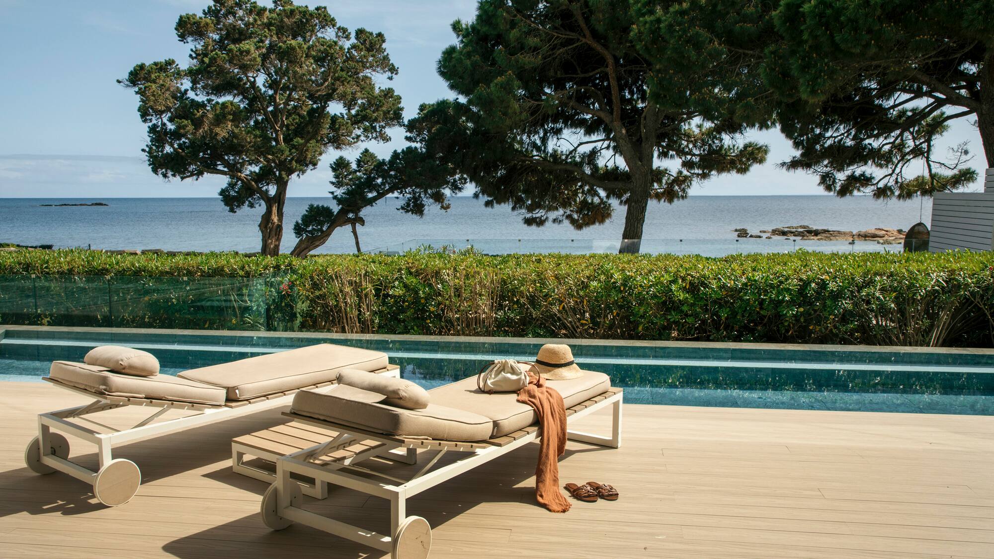 a pool with lounge chairs and a hat on it