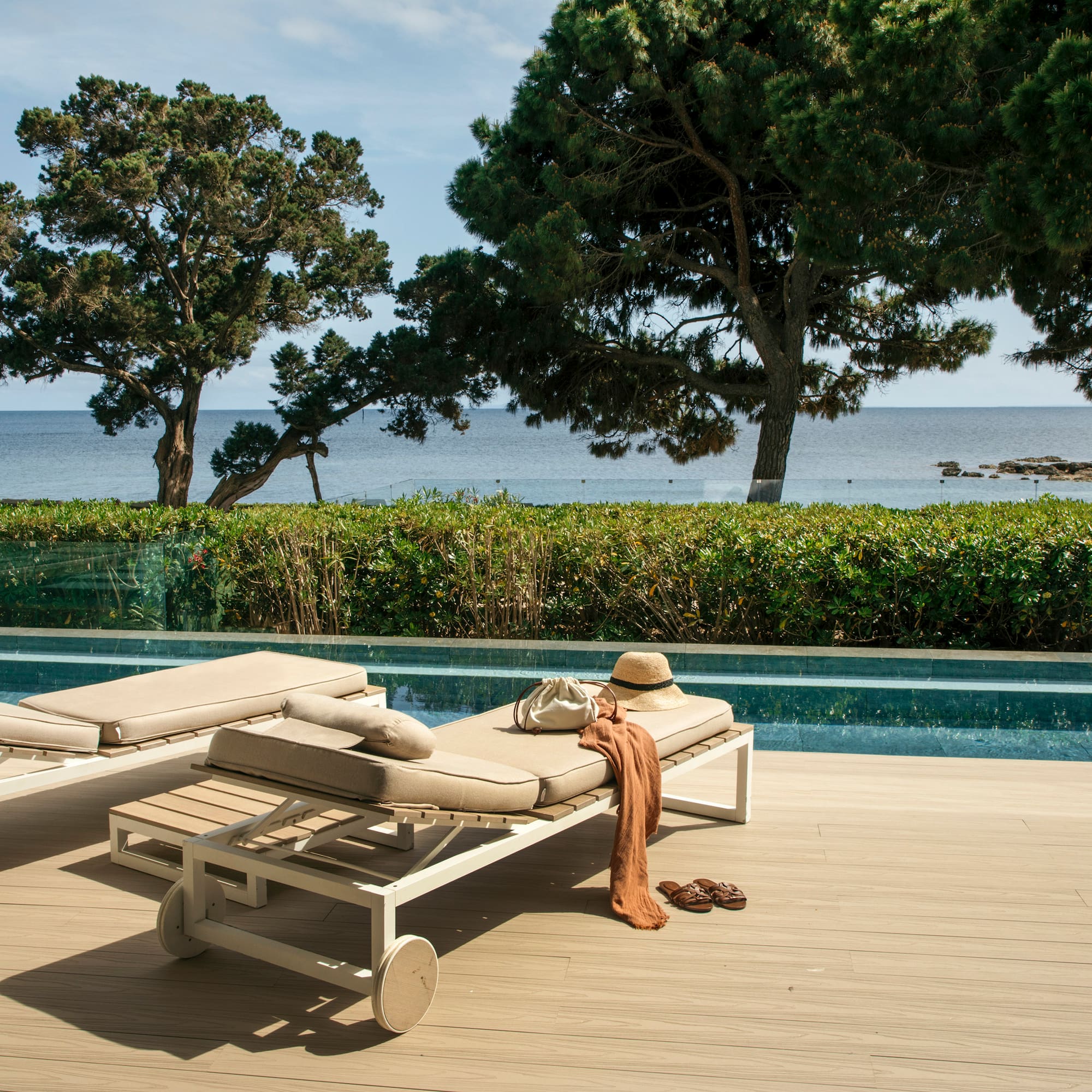 a pool with lounge chairs and a hat on it