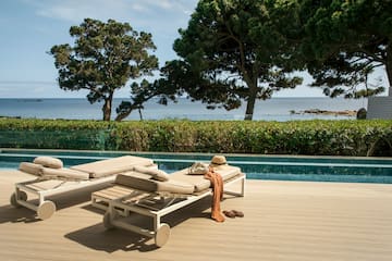 a pool with lounge chairs and a hat on it