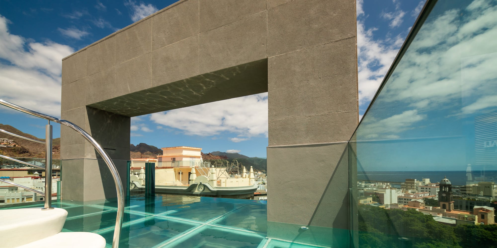 a glass pool with a bridge over water