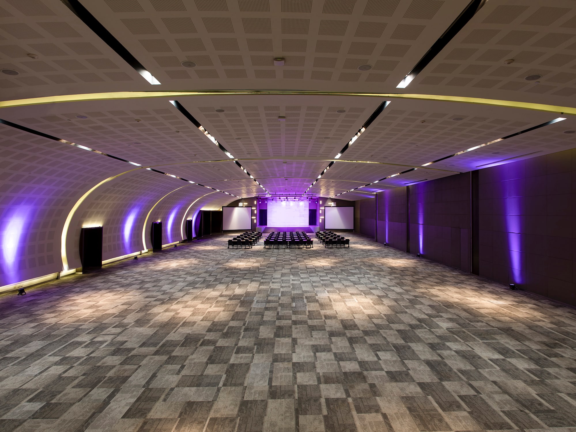 a room with a large ceiling and a row of chairs