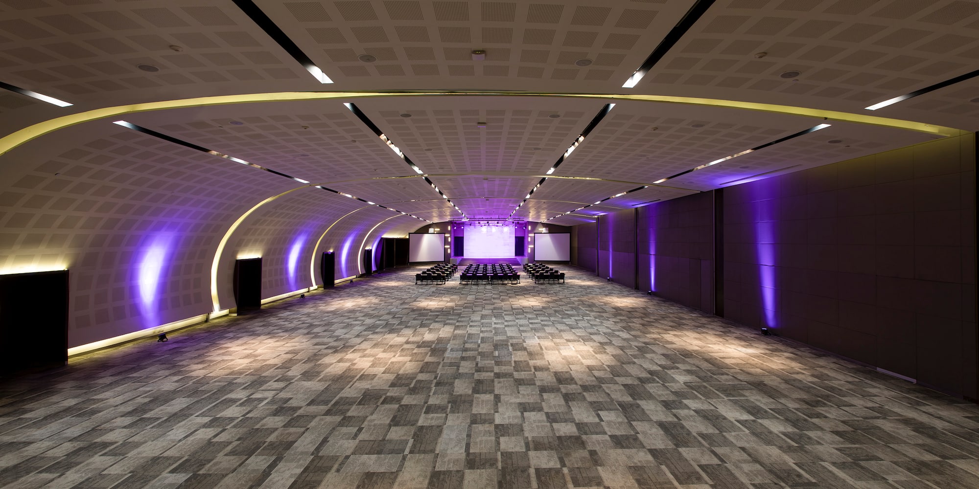 a room with a large ceiling and a row of chairs