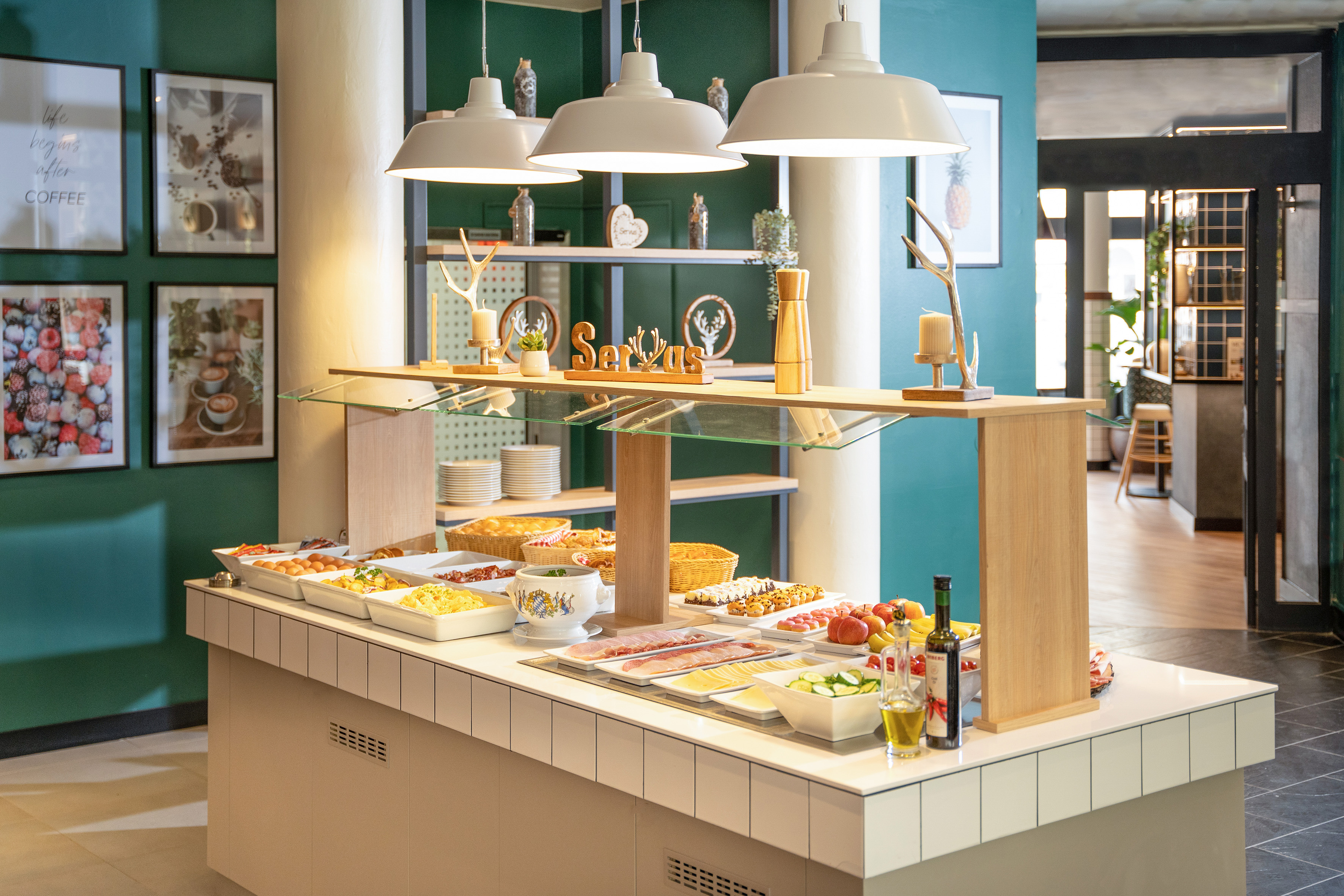 Hotel breakfast buffet with fresh hot & cold food, fruits, pastries on a modern counter.