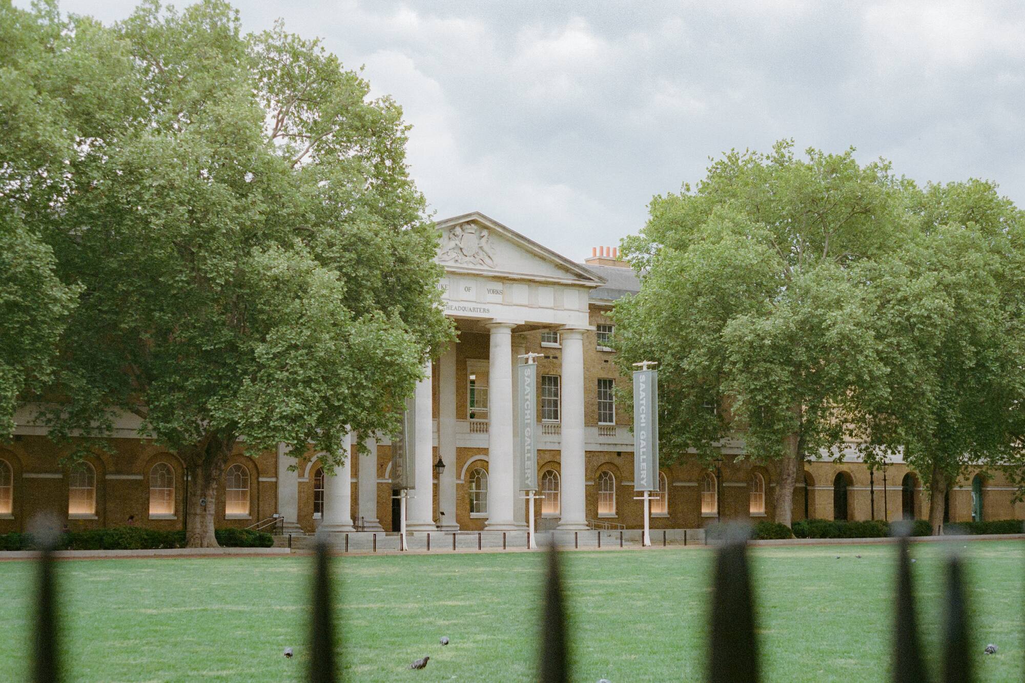 Saatchi Gallery at Duke of York's Headquarters, neoclassical columns, green trees.