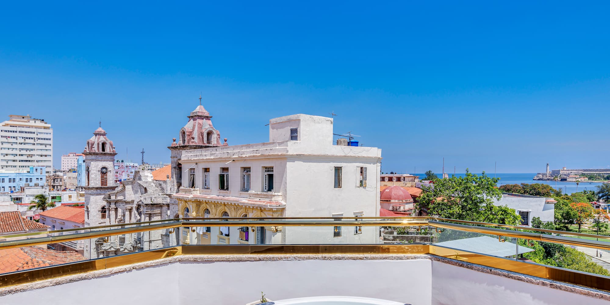 a hot tub on a rooftop overlooking a city