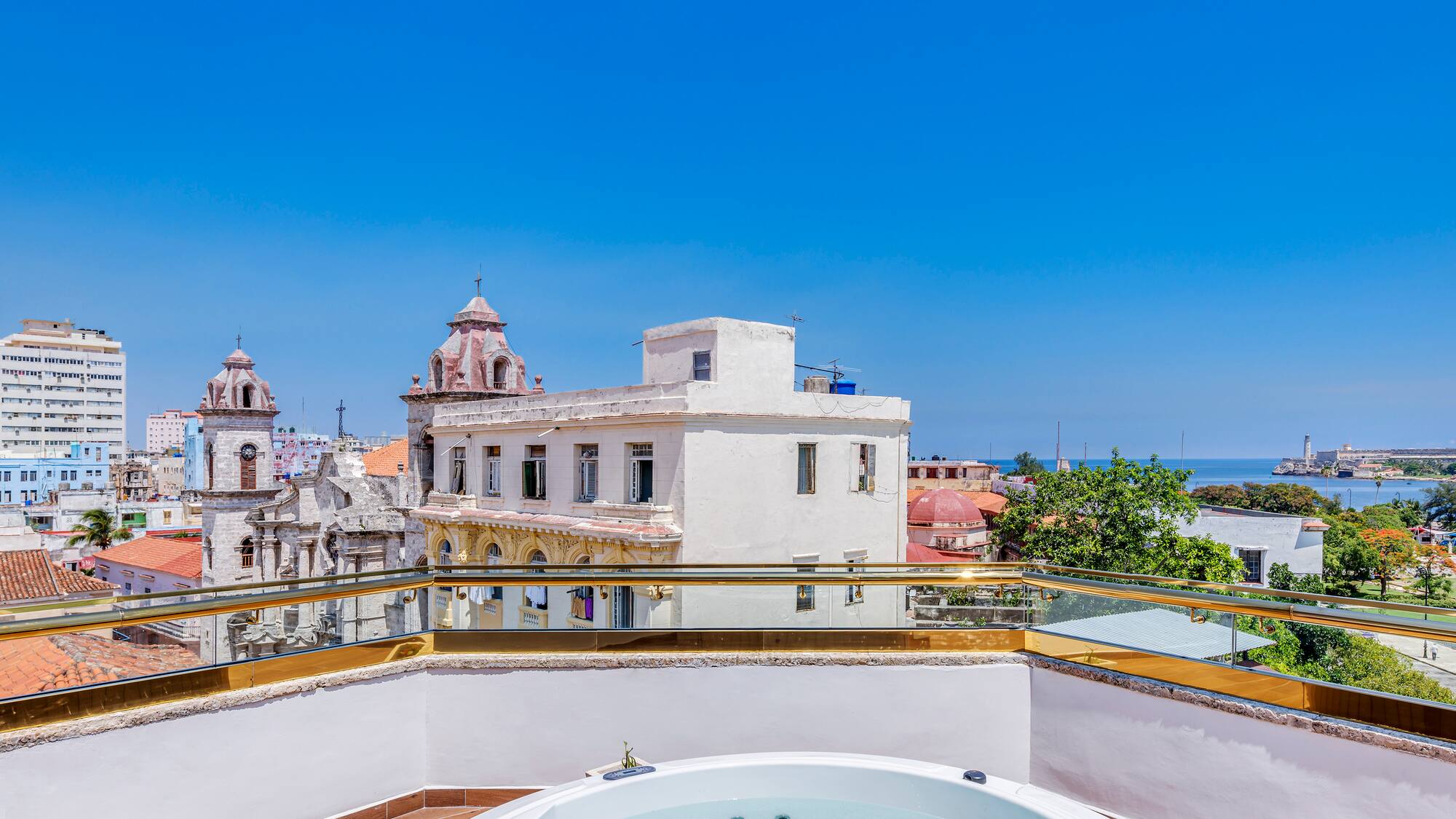 a hot tub on a rooftop overlooking a city