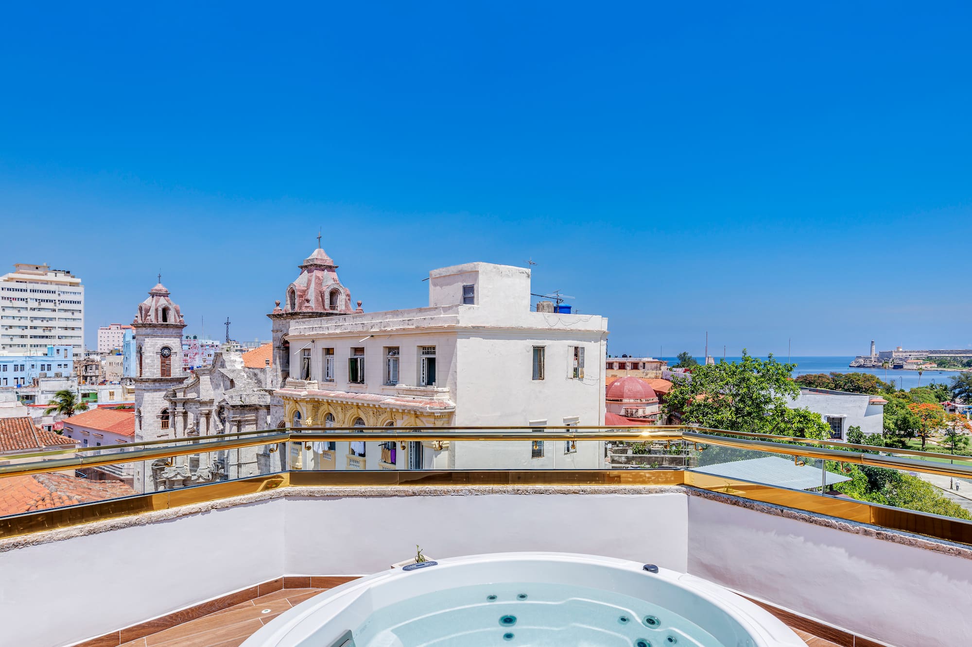 a hot tub on a rooftop overlooking a city