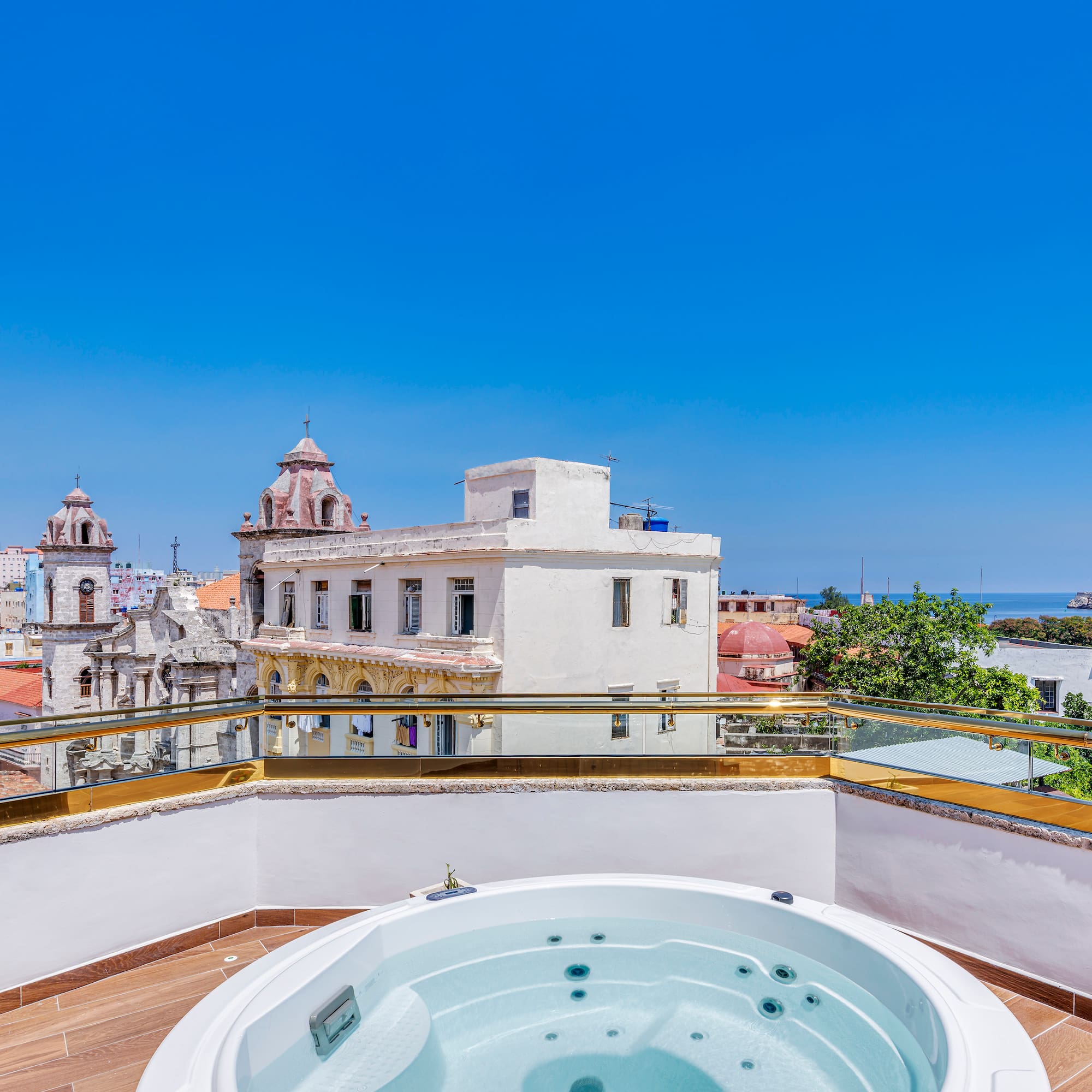 a hot tub on a rooftop overlooking a city